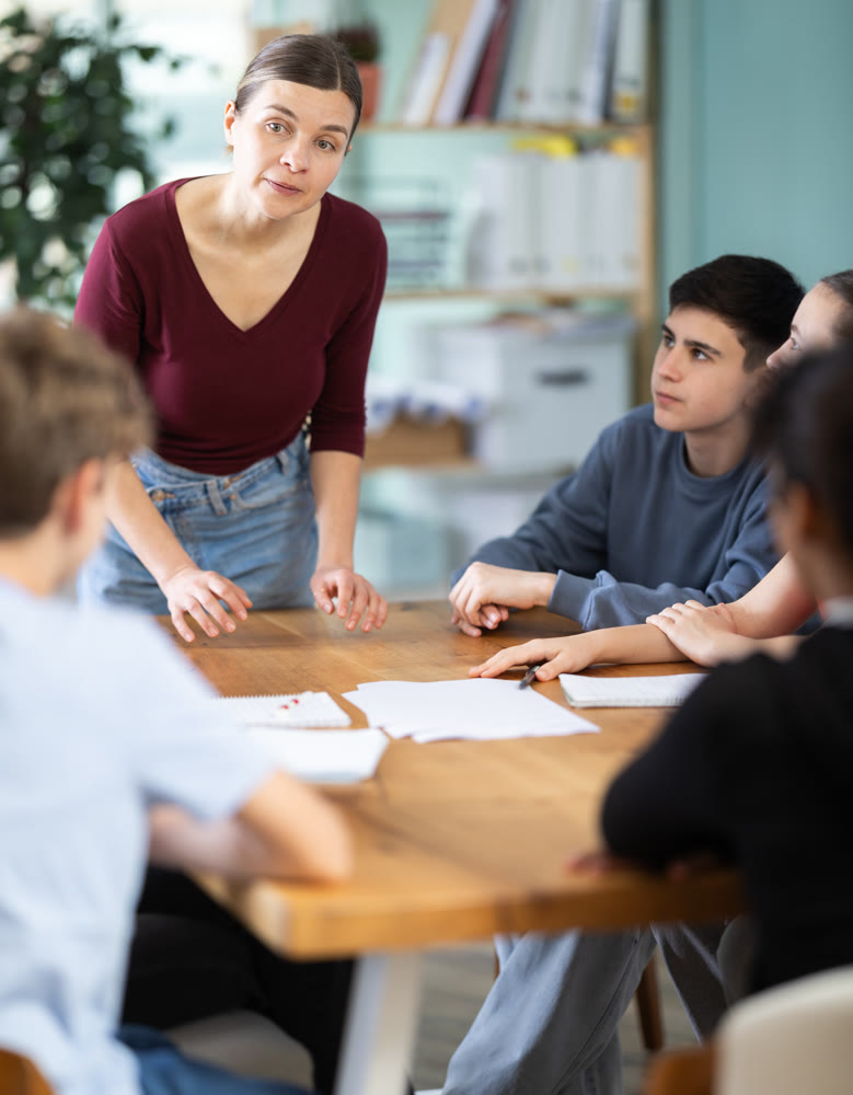 Teen gathering to round table talks to carrying out disputing under woman coach guidance.