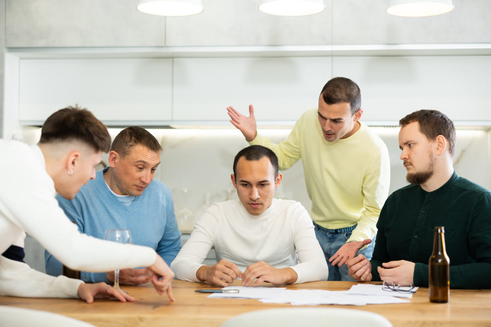 Friends comforting upset man receiving unpleasant news