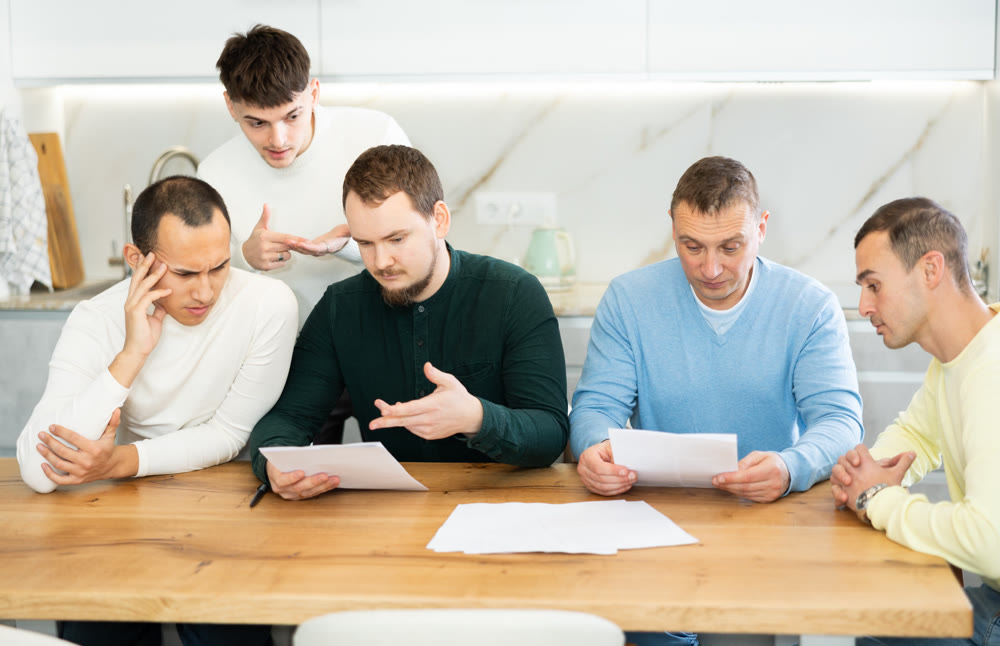 Friends comforting upset man receiving unpleasant news