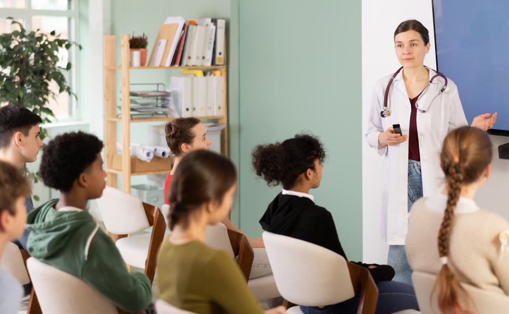 Doctor teacher communicates with students in the class