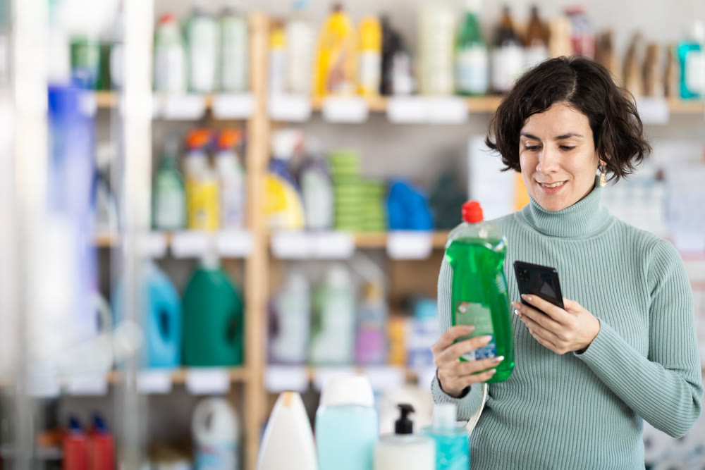Adult woman scanning qr code for dishwashing