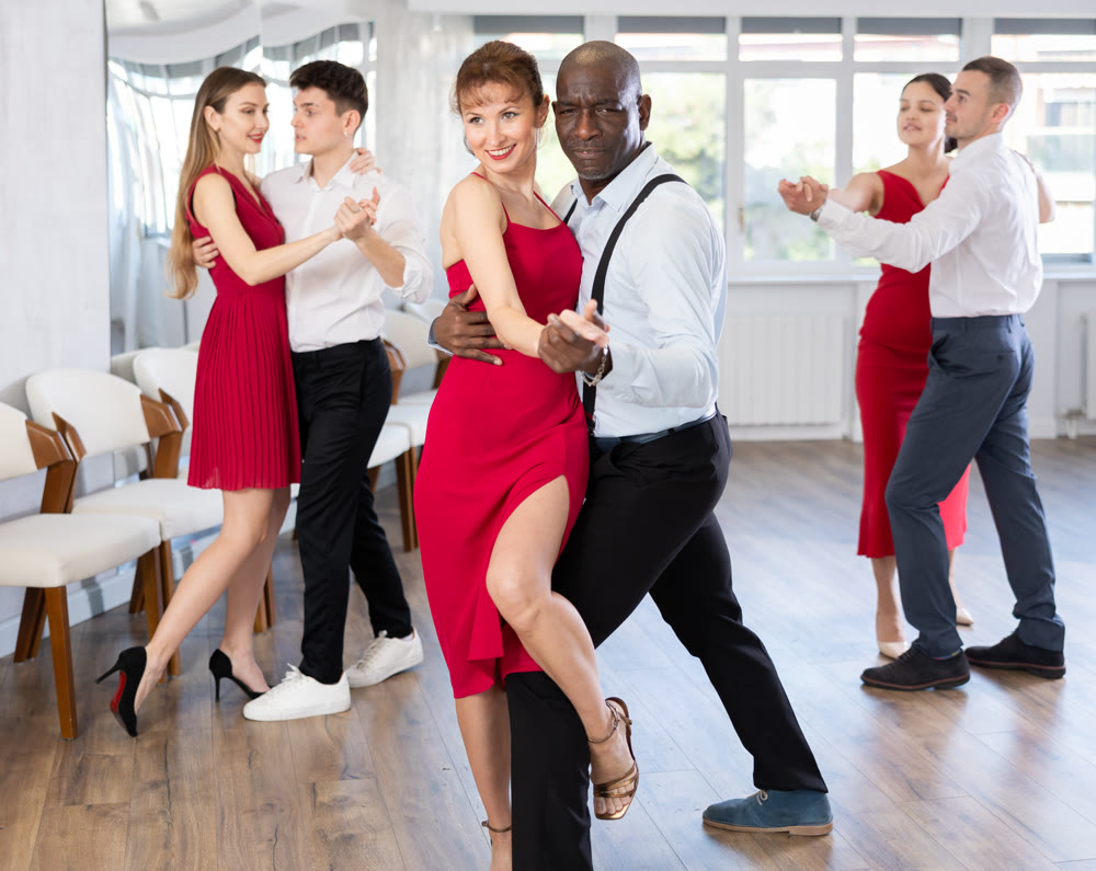 Adult man and adult woman dance tango