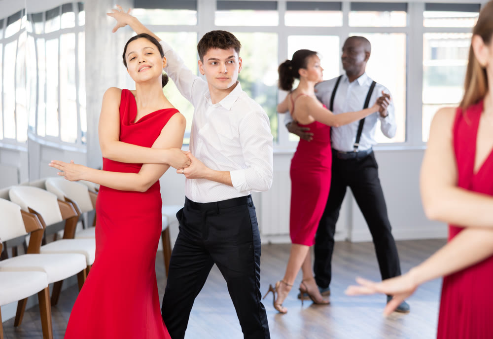Young guy and young woman dance tango
