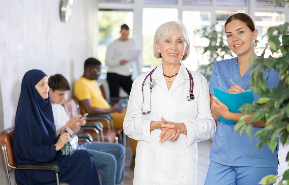 Portrait of an experienced female doctor and a young nurse in medical clinic