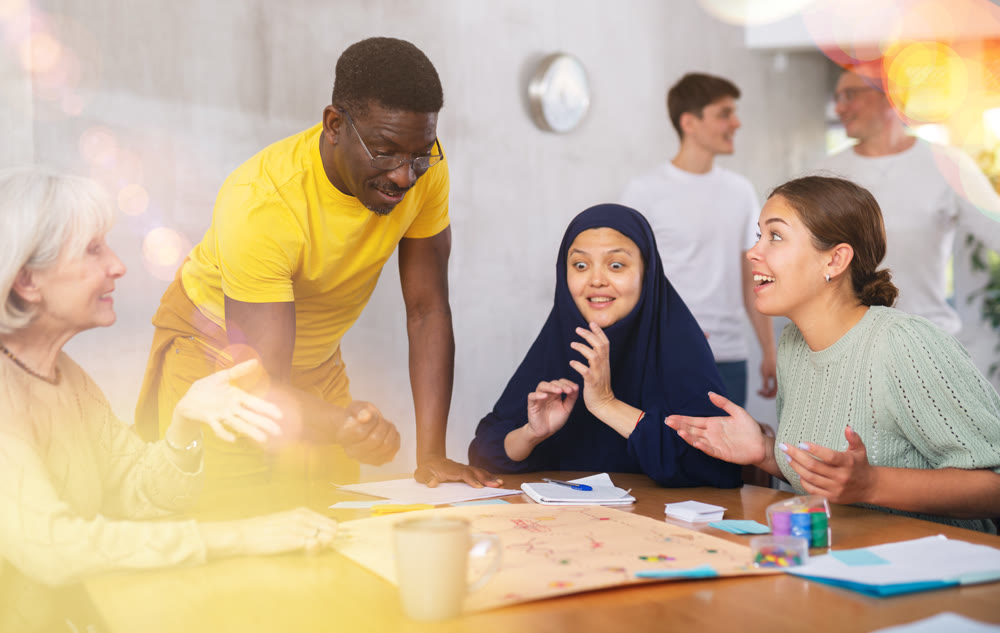 Group of multinational people playing board game