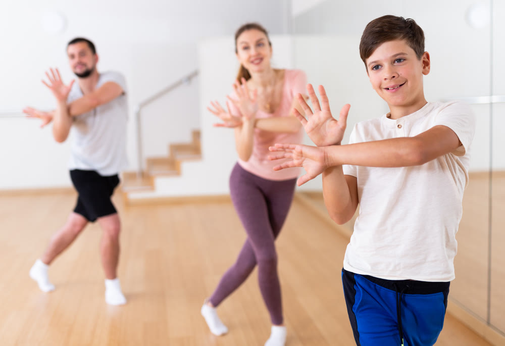 Boy exercising during family dance class