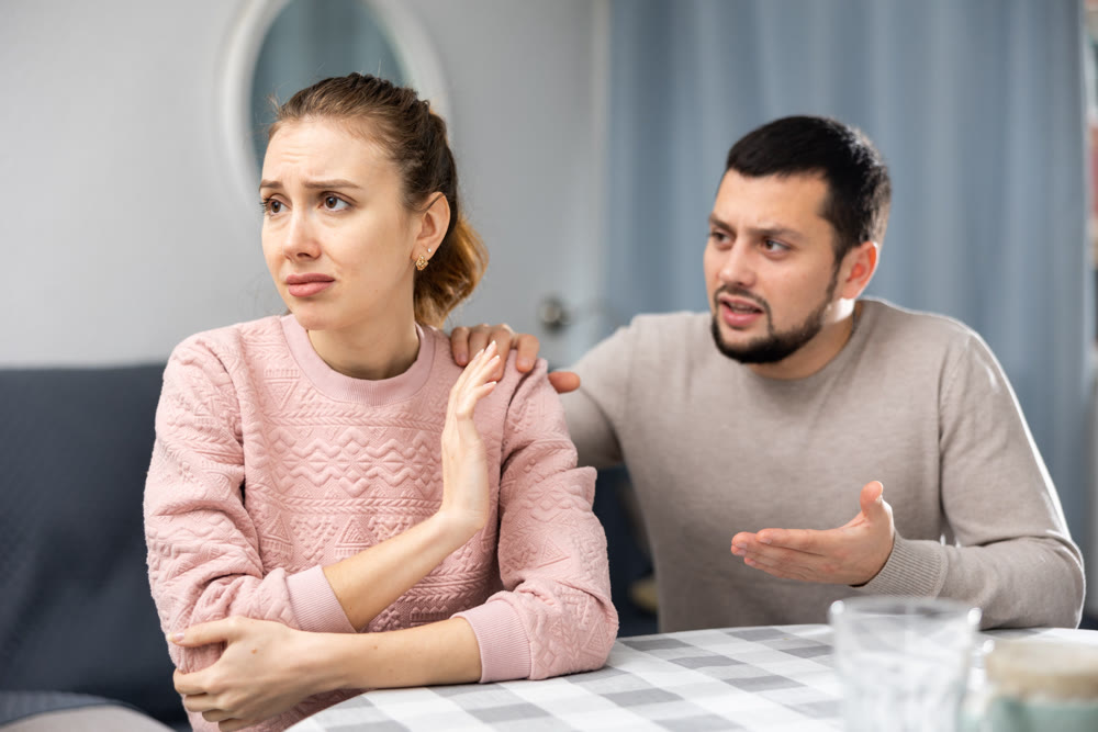 Young adult couple quarreling at home