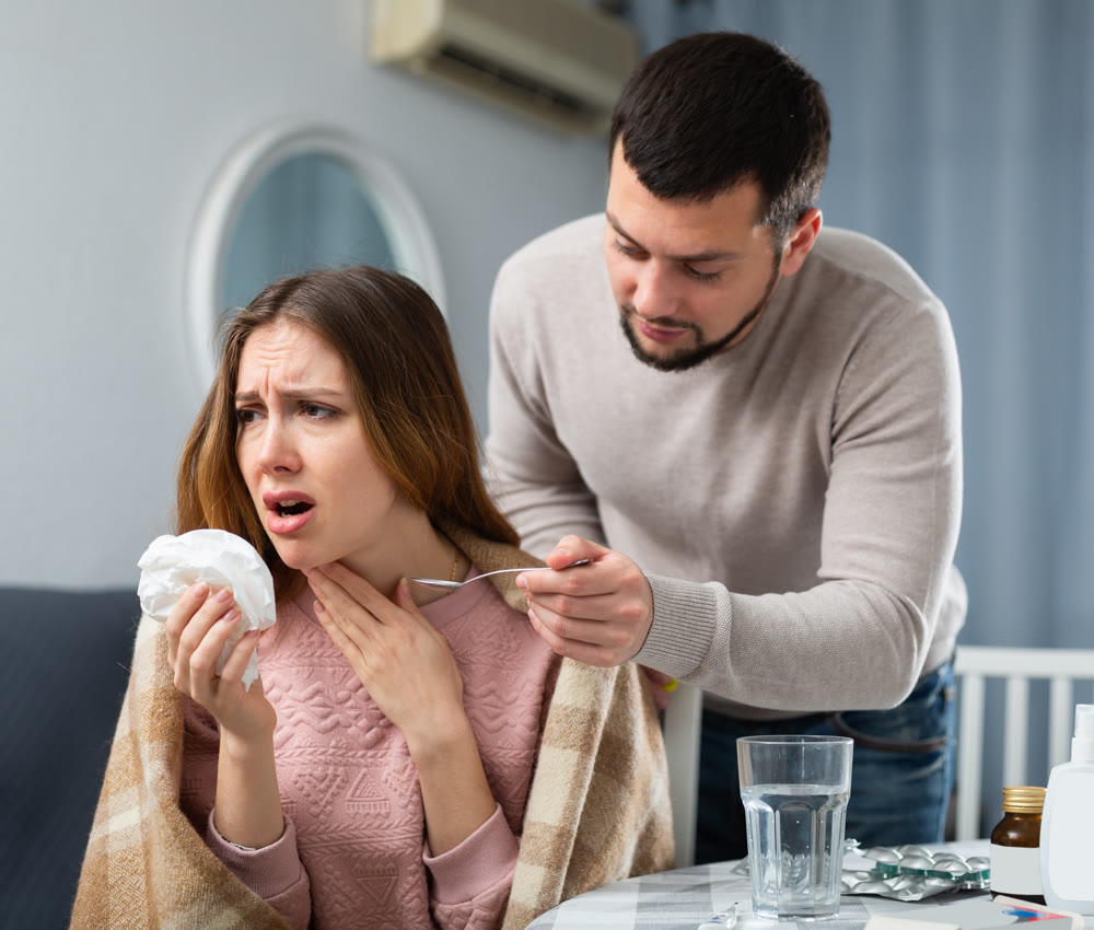 Sick woman resting at home with husband