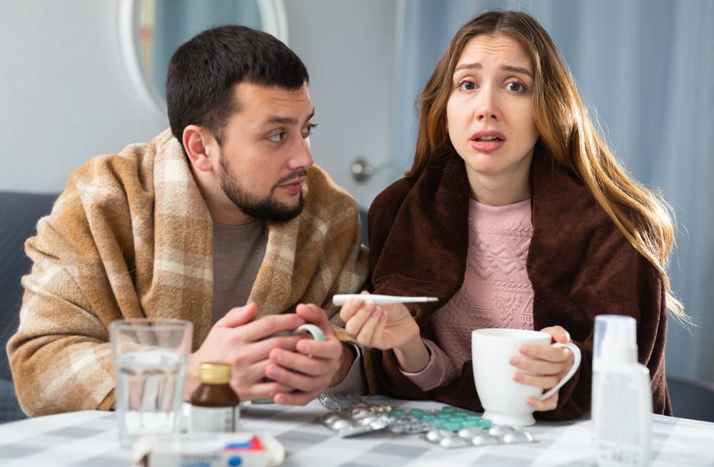 Sick couple suffering from flu at home