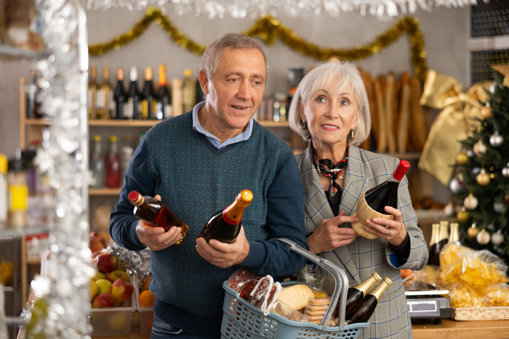 Elderly couple examines alcohol in store on eve of New Year holidays