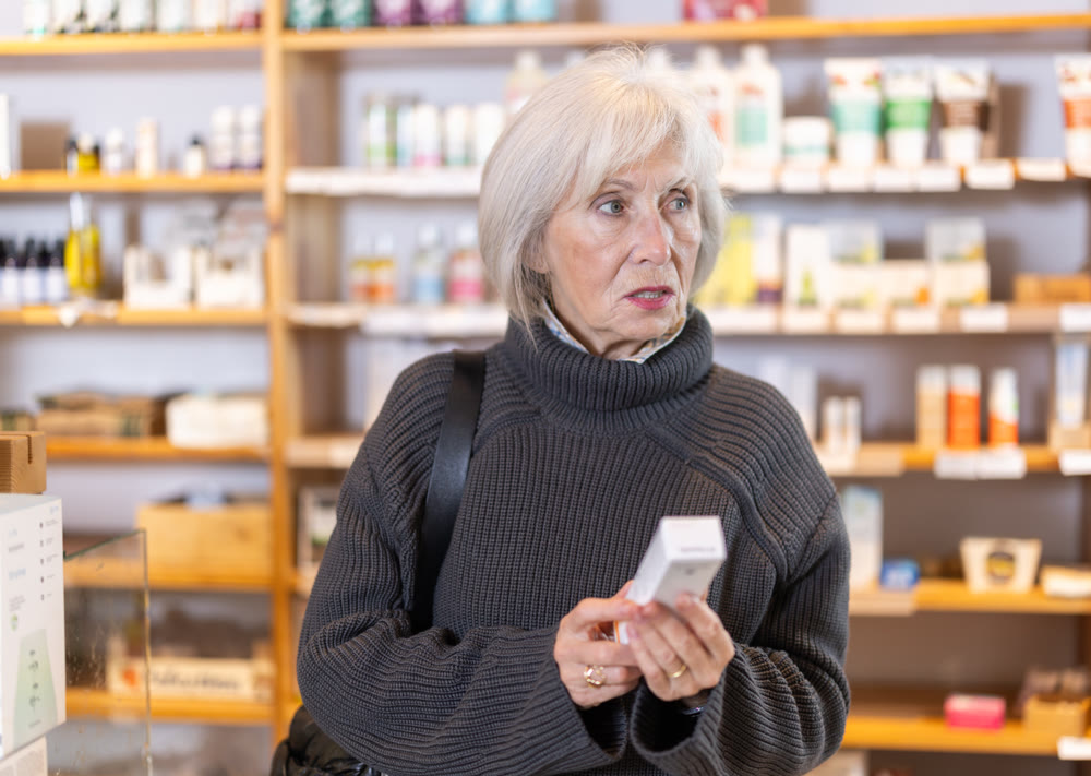 Senior woman selects dietary supplement to maintain active lifestyle