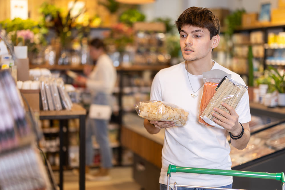 Store visitor, guy in sales area choosing pasta