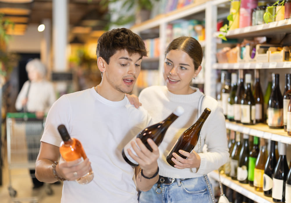 Couple choosing wine in the supermarket