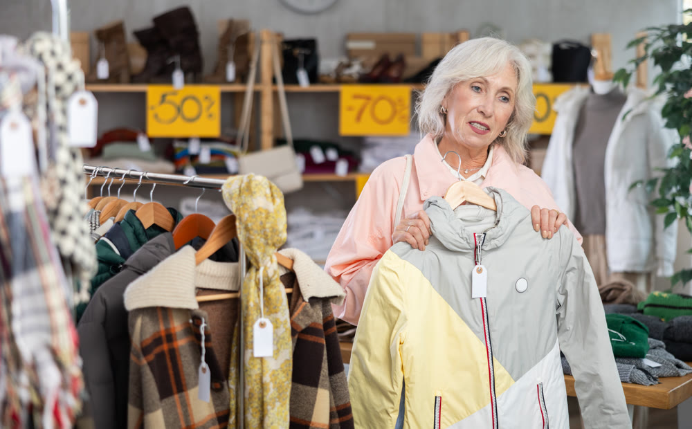 Mature woman choosing a jacket in a store