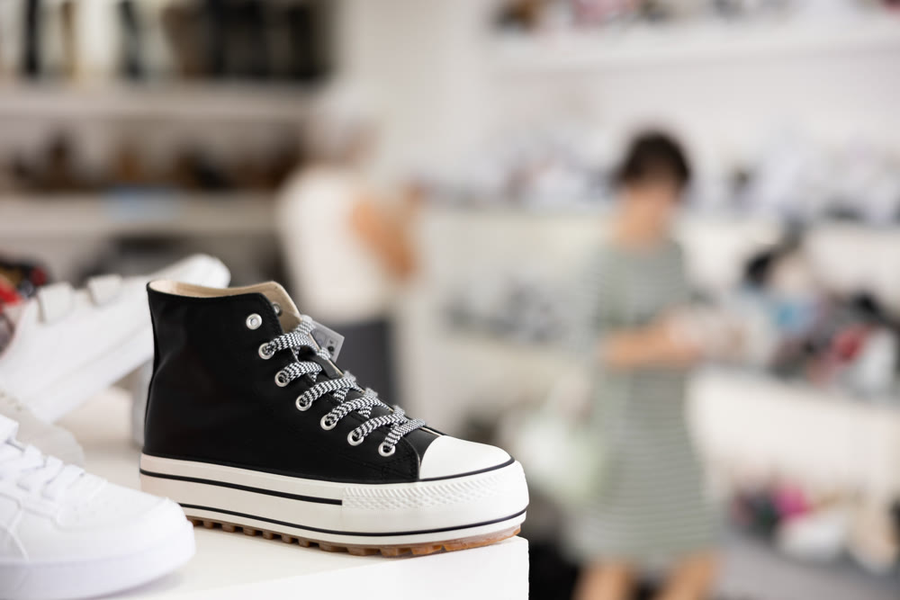 Sneakers displayed on shelf in shoe store