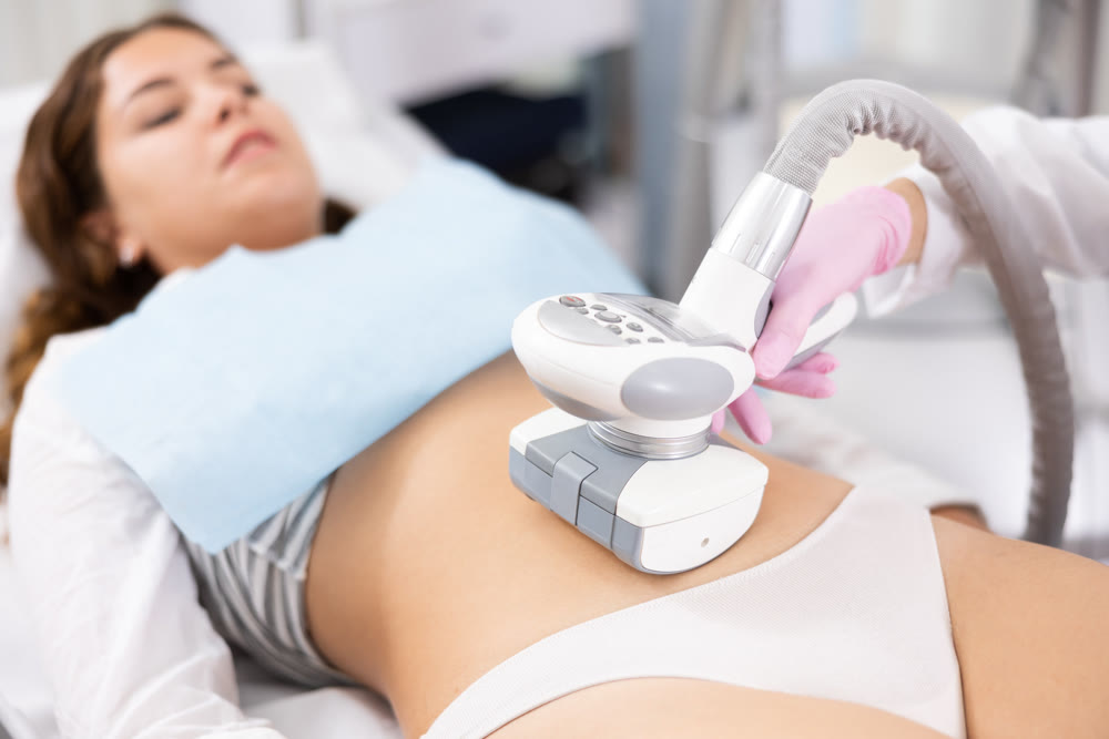 LPG massage device applied on young woman's belly