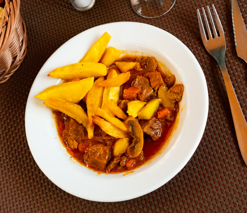 Braised veal with baked potato and mushrooms