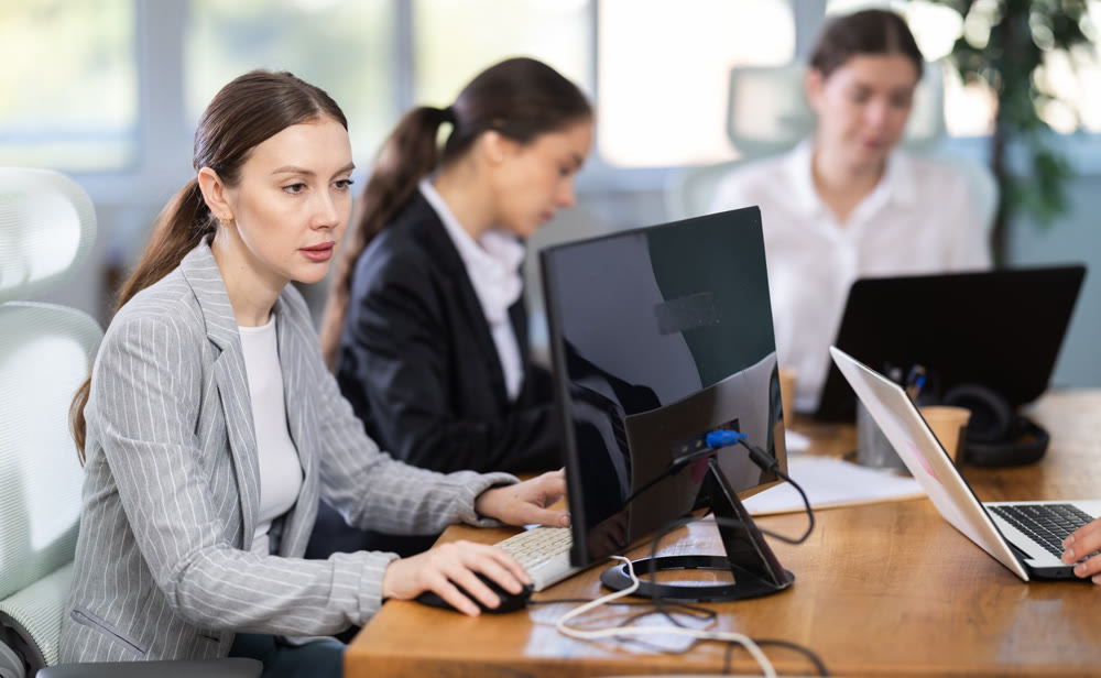 Young woman is a qualified specialist, works in a modern office