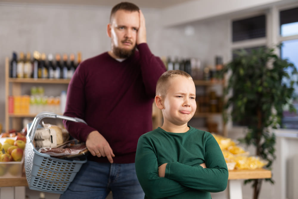 Little boy behaving capricious in grocery store