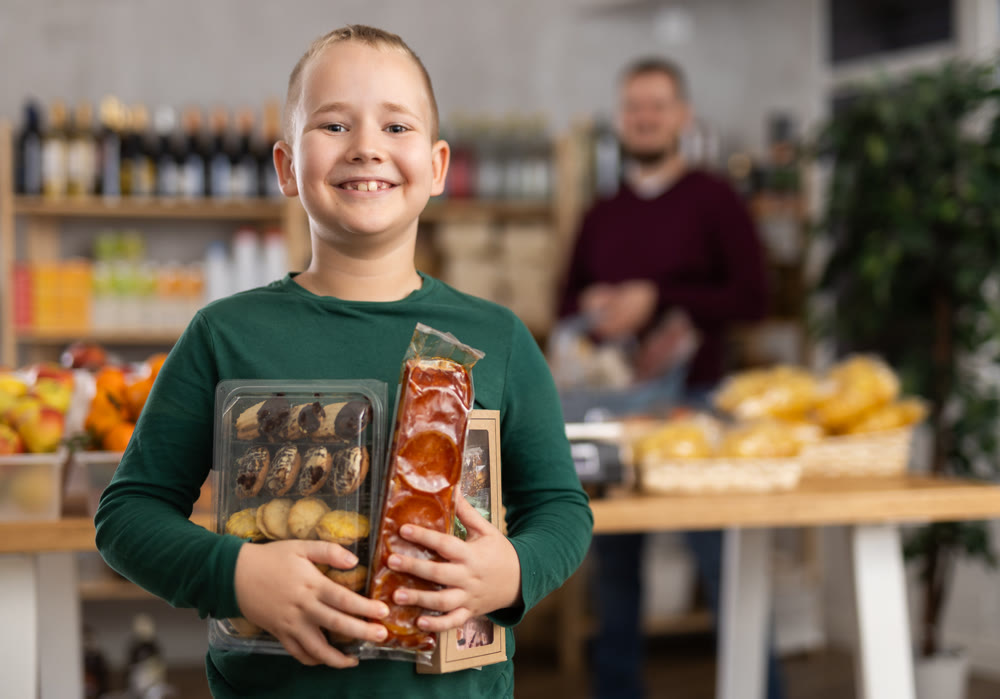 Child with sweets in the store