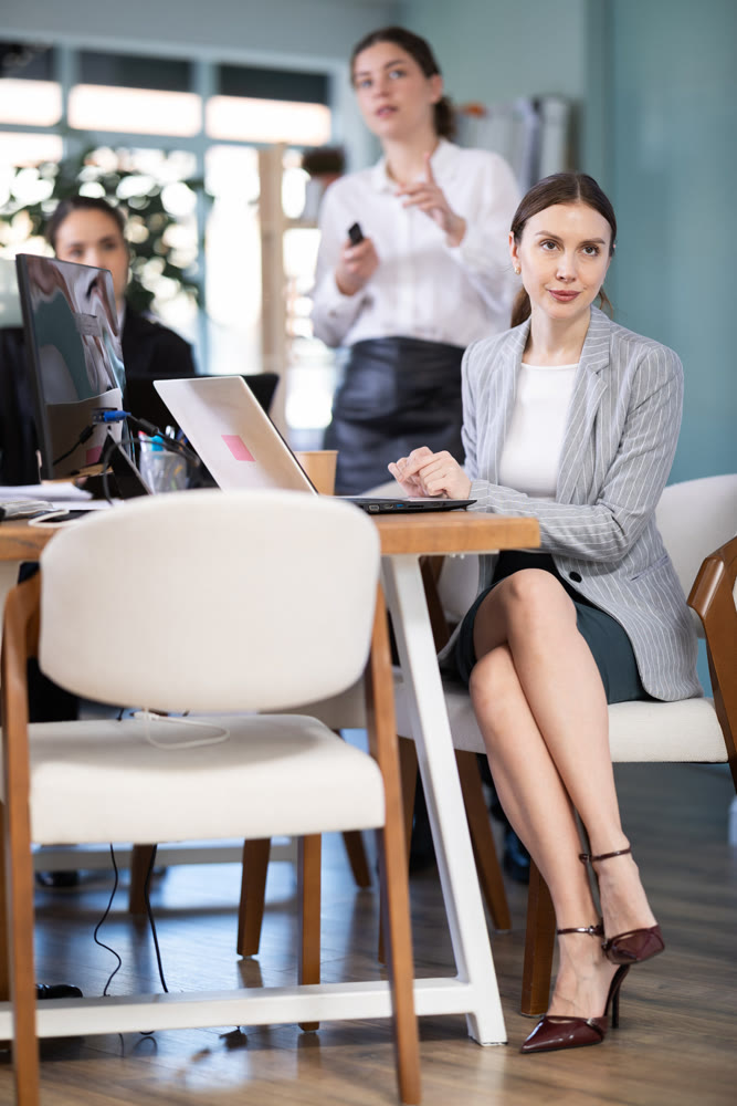 Young woman watching presentation in office