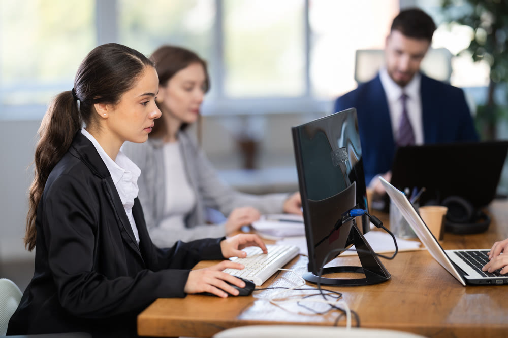 Group of young colleagues working in office