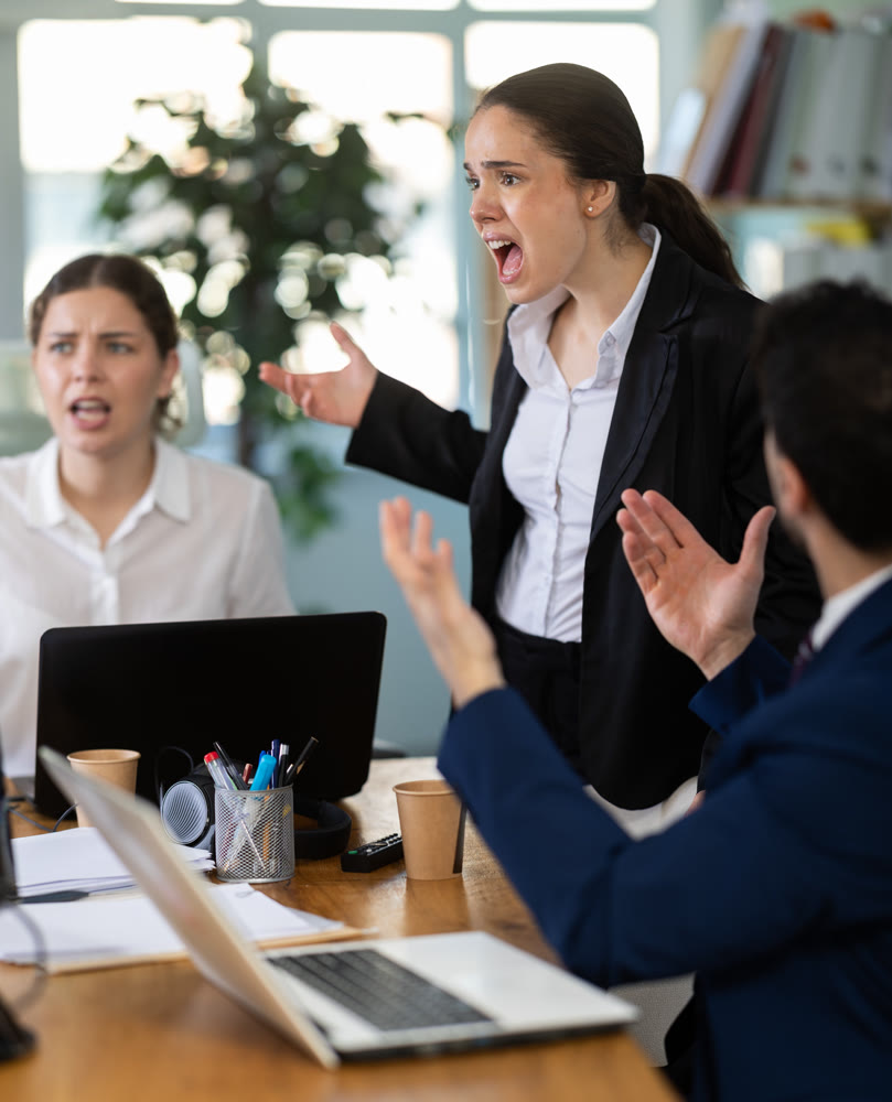 Group of men and women arguing loudly in office