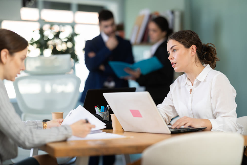 Young woman is a qualified specialist, works in a modern office