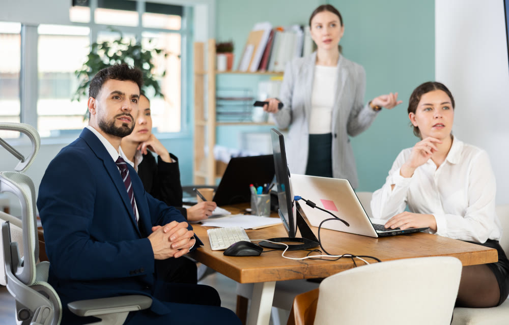 Employees of a modern company watch the presentation