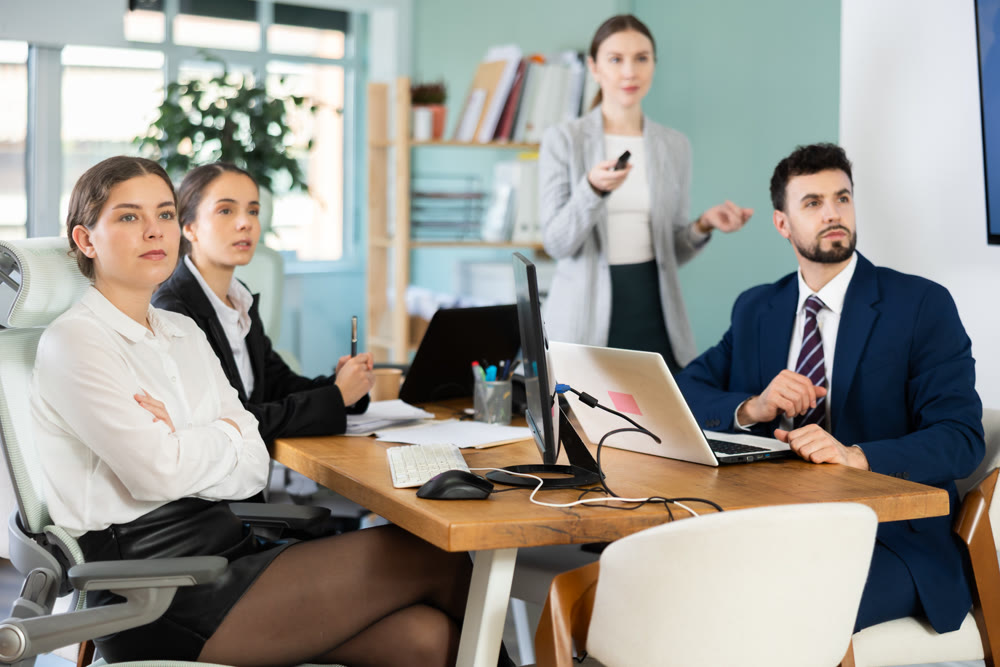 Colleagues watching a project presentation in modern office