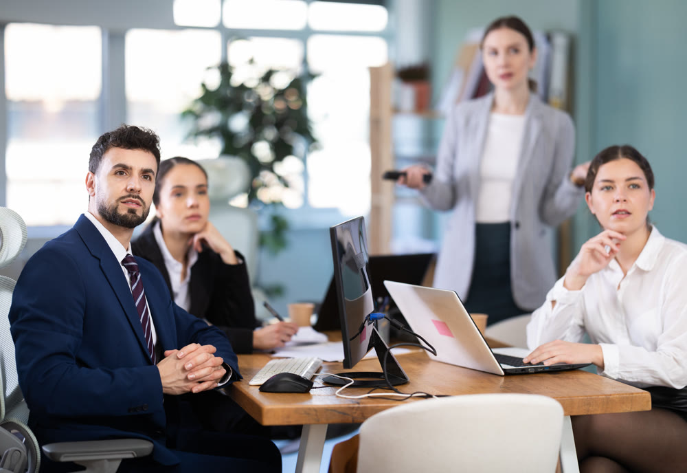 Employees of a modern company watch the presentation