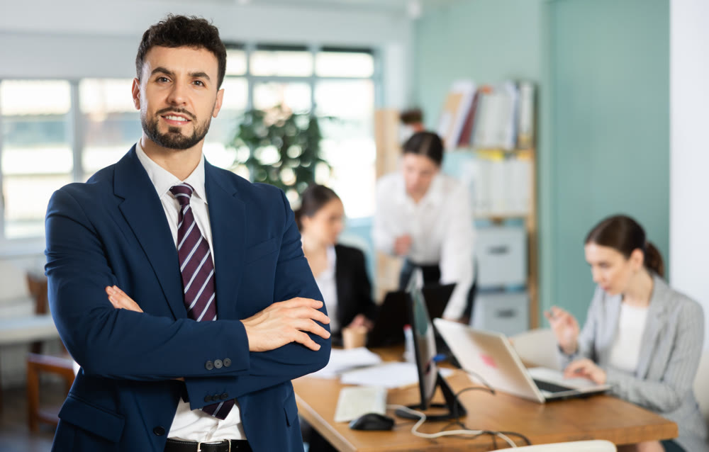 Young man welcoming clients at workplace