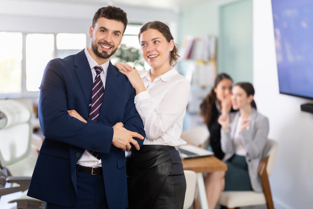 Young woman flirts with male colleague in office