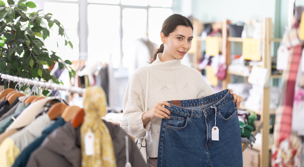 Armenian woman buys stylish jeans in a clothing store