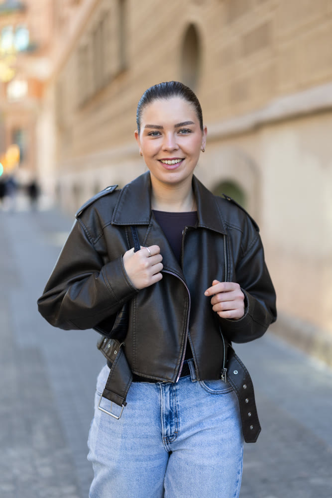 Young female tourist walks through a spring city and takes in sights