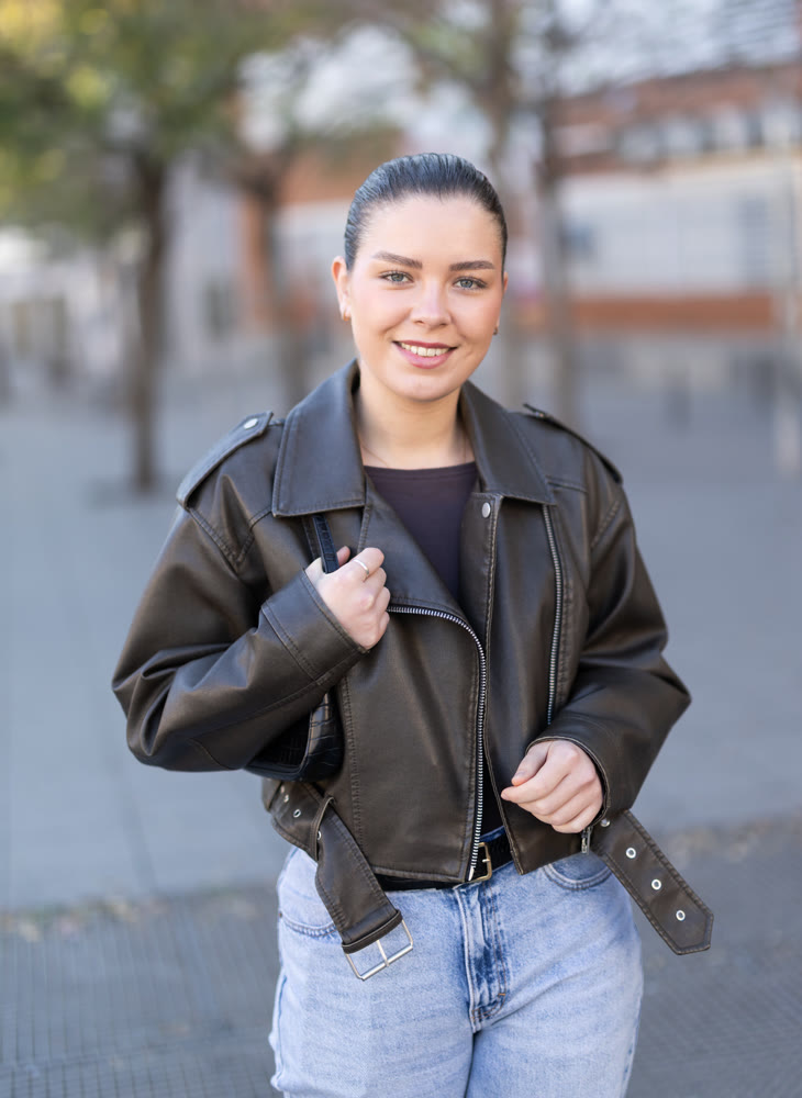 Young female tourist walks through a spring city and takes in sights