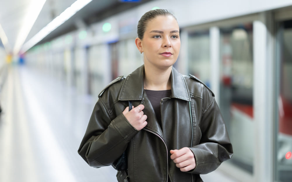 Pretty girl walks along the platform waiting for subway train