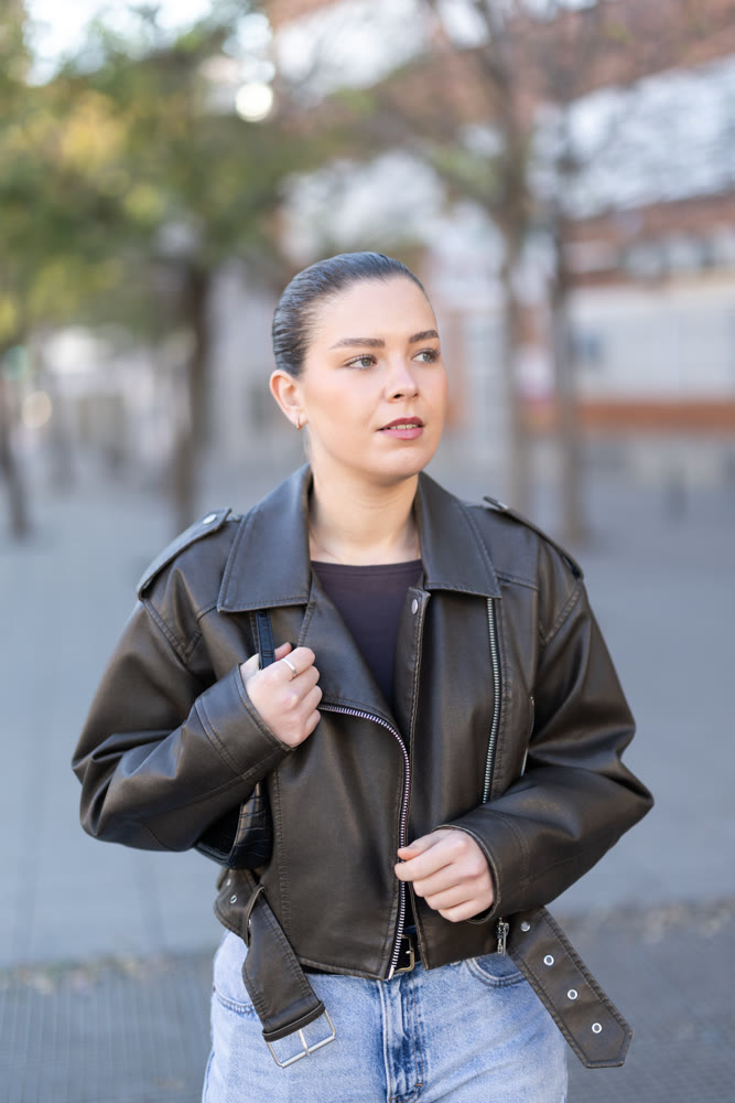 Young female tourist walks through a spring city and takes in sights