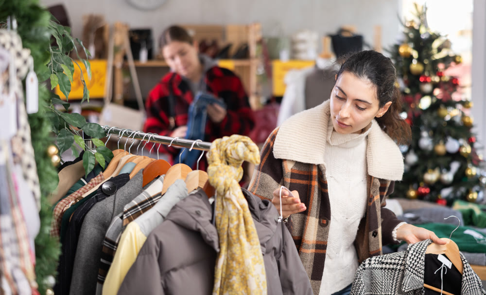 Armenian woman choosing outerwear in the store