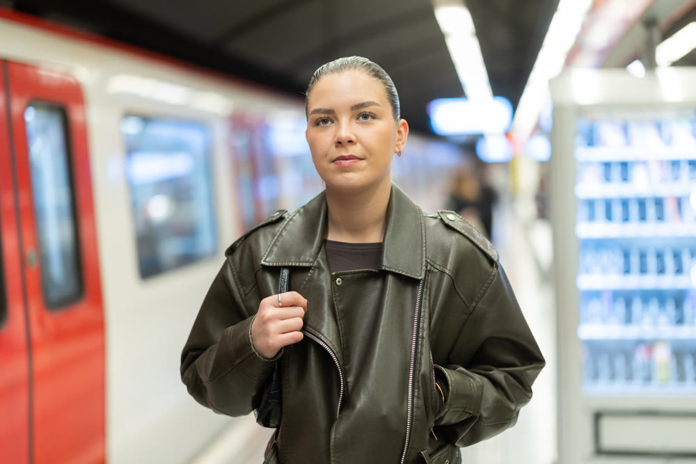 Young woman standing at metro station