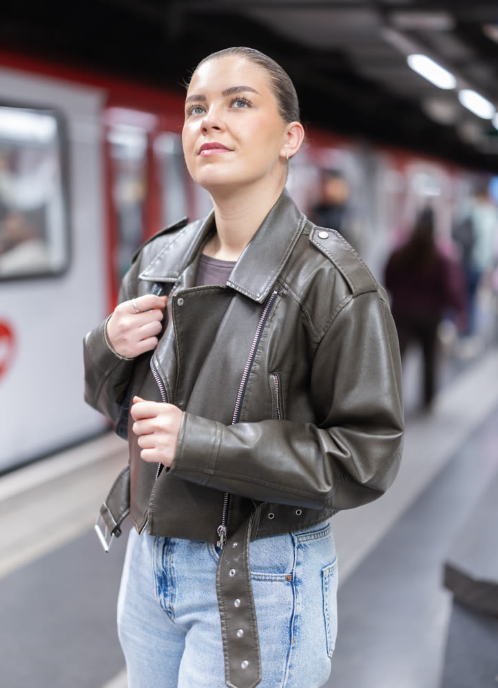 Young woman standing at metro station