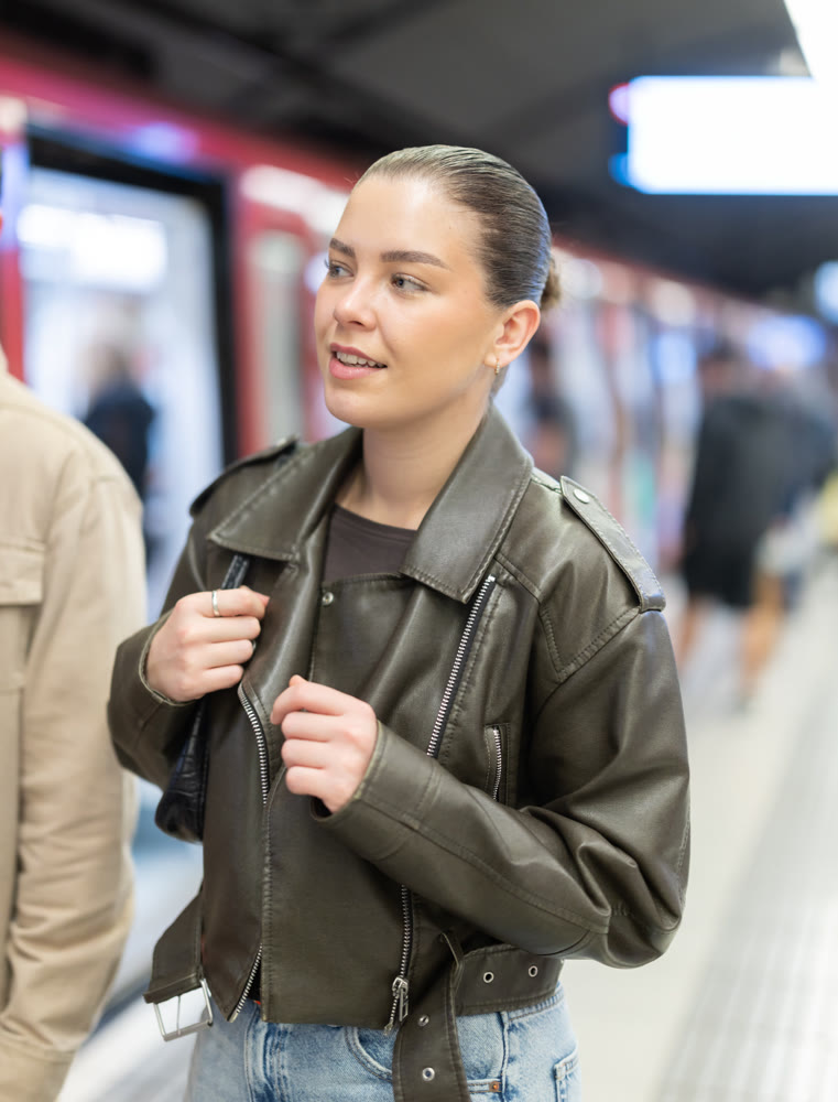 Pretty girl walks along the platform waiting for subway train