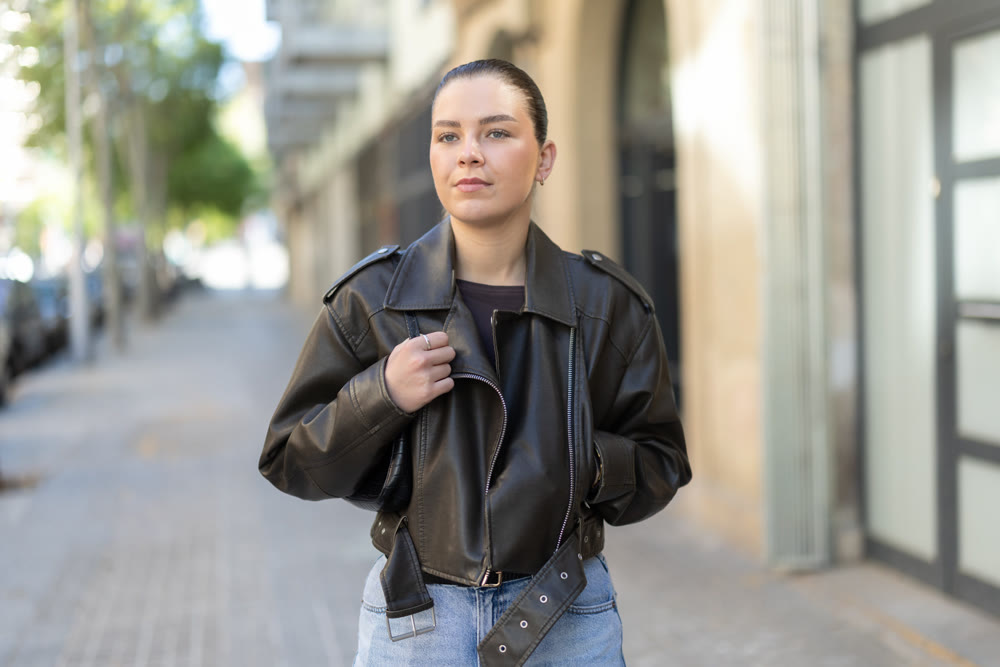 Young female tourist walks through a spring city and takes in sights