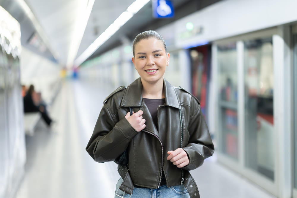 Pretty girl walks along the platform waiting for subway train