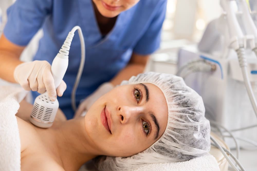 Female patient receiving hardware procedure on chest and neck area using cooling attachment