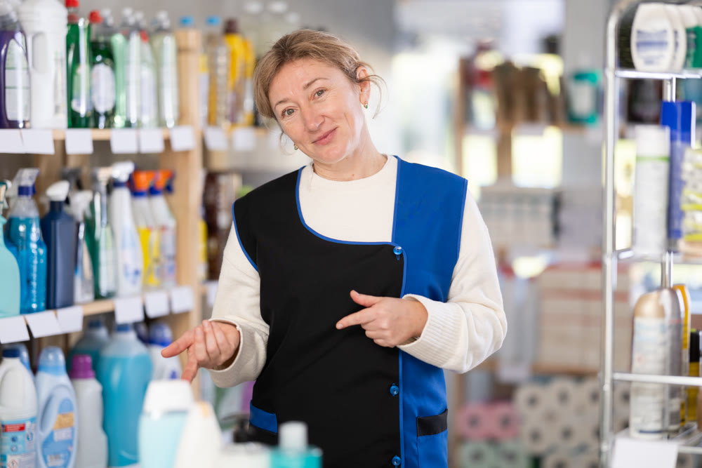 Adult woman seller in household chemicals store