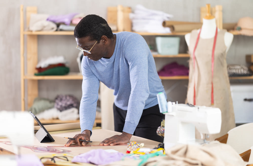Fashion designer creating clothing patterns in studio