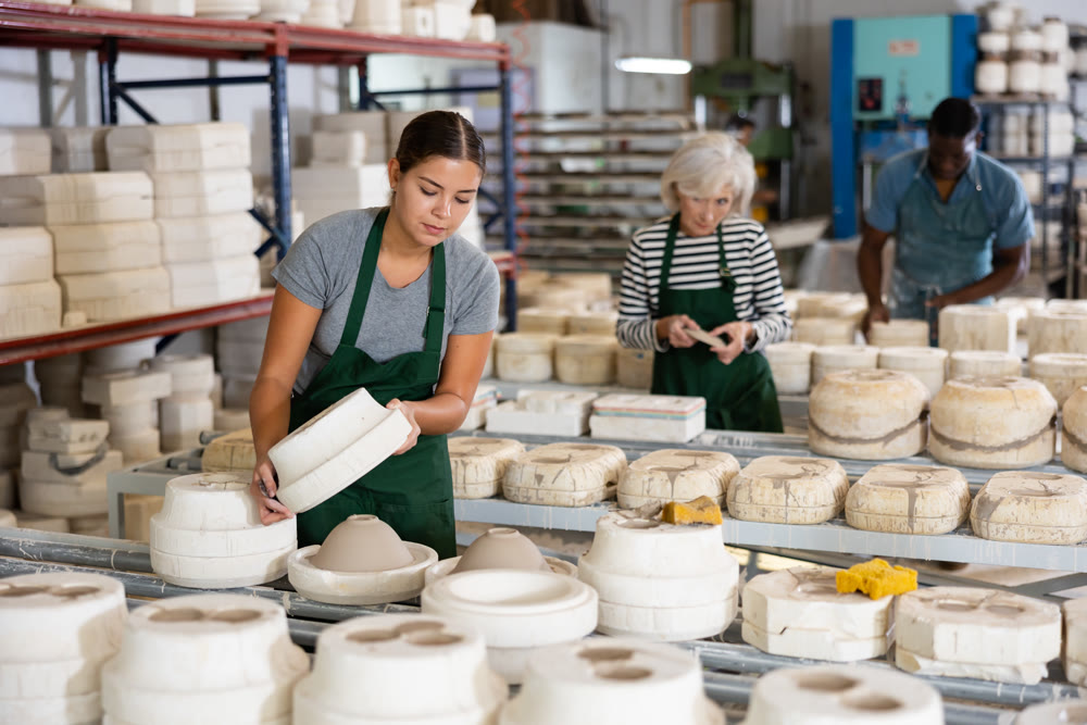 Woman ceramist working in pottery workshop