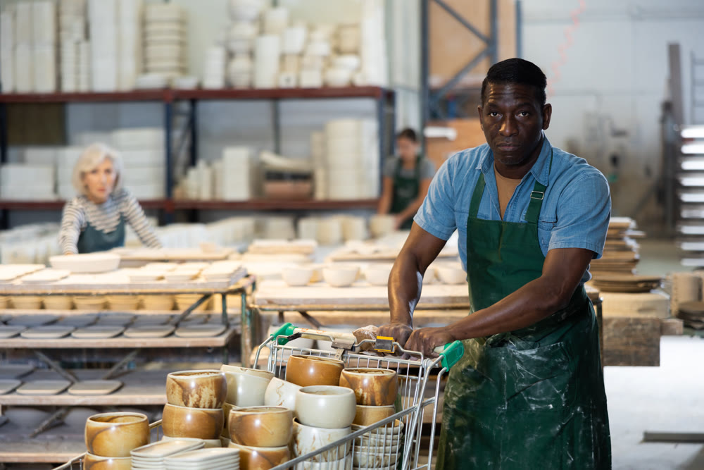 Woman ceramist working in pottery workshop
