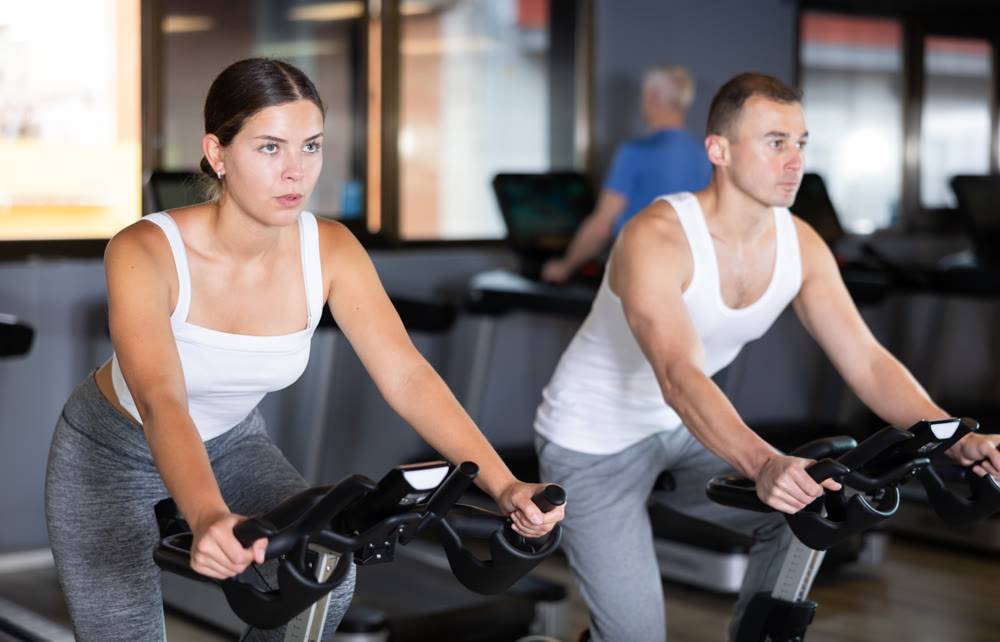 Young woman exercising on exercise bike